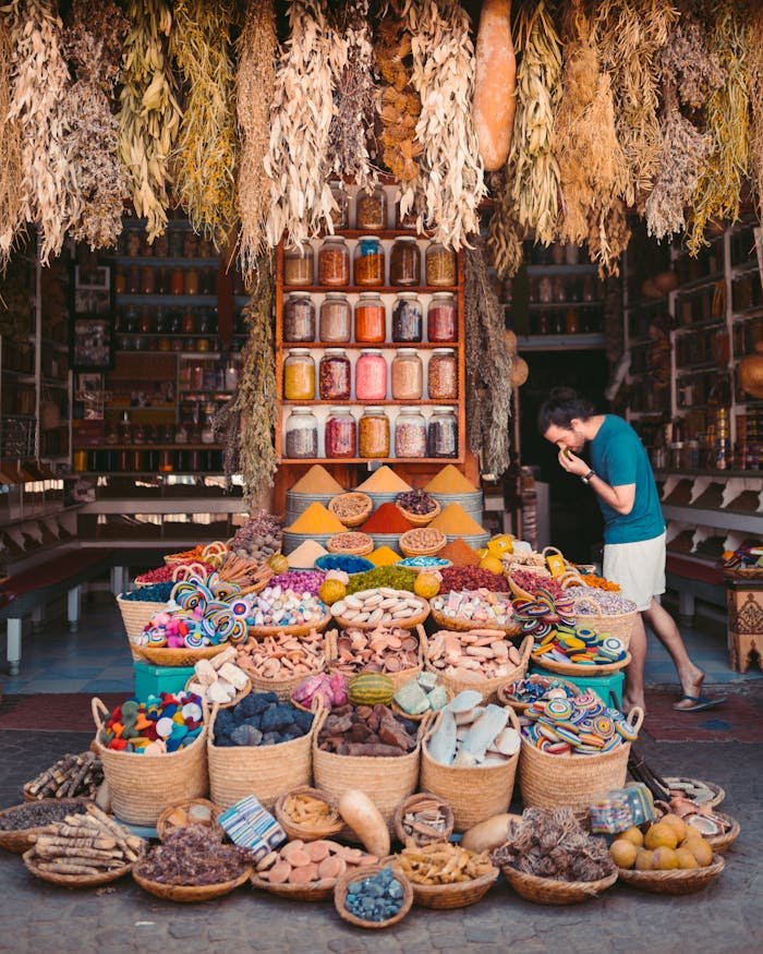services-02 Vibrant display of spices and goods in a Marrakesh street market showcasing Moroccan culture.