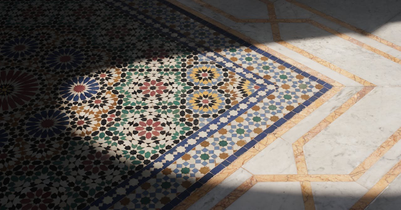 Intricate Moroccan mosaic tile flooring design with shadow contrast and vibrant colors.