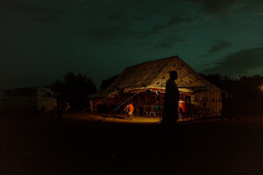 people-standing-near-brown-wooden-house-during-night-time-fj6-dkylk-y