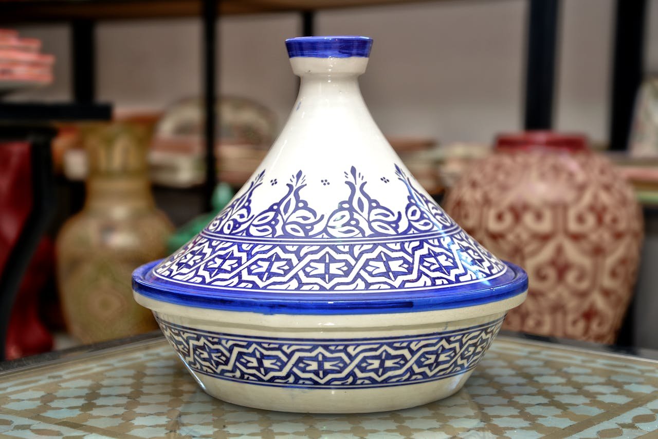 High-quality image of a traditional Moroccan tagine pot with intricate blue patterns, perfect for culinary themes.